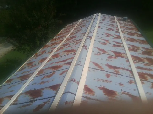 Rusted metal roof panels with new wood purlins before replacement — Storm Damage Roof Repair in San Dimas by Roofing Brothers