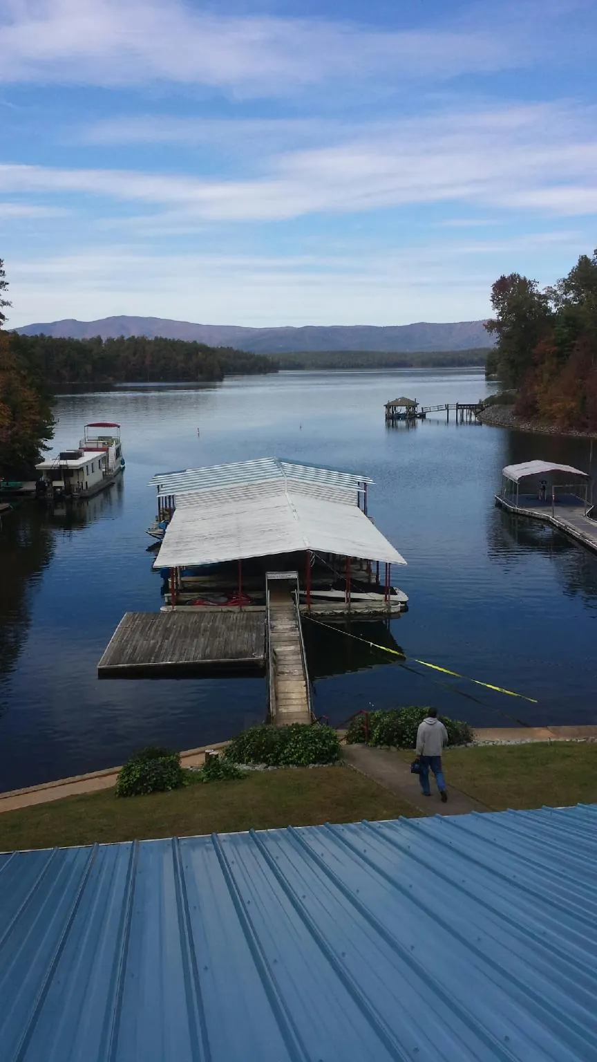 View across a lake from a newly installed blue metal roof in San Dimas