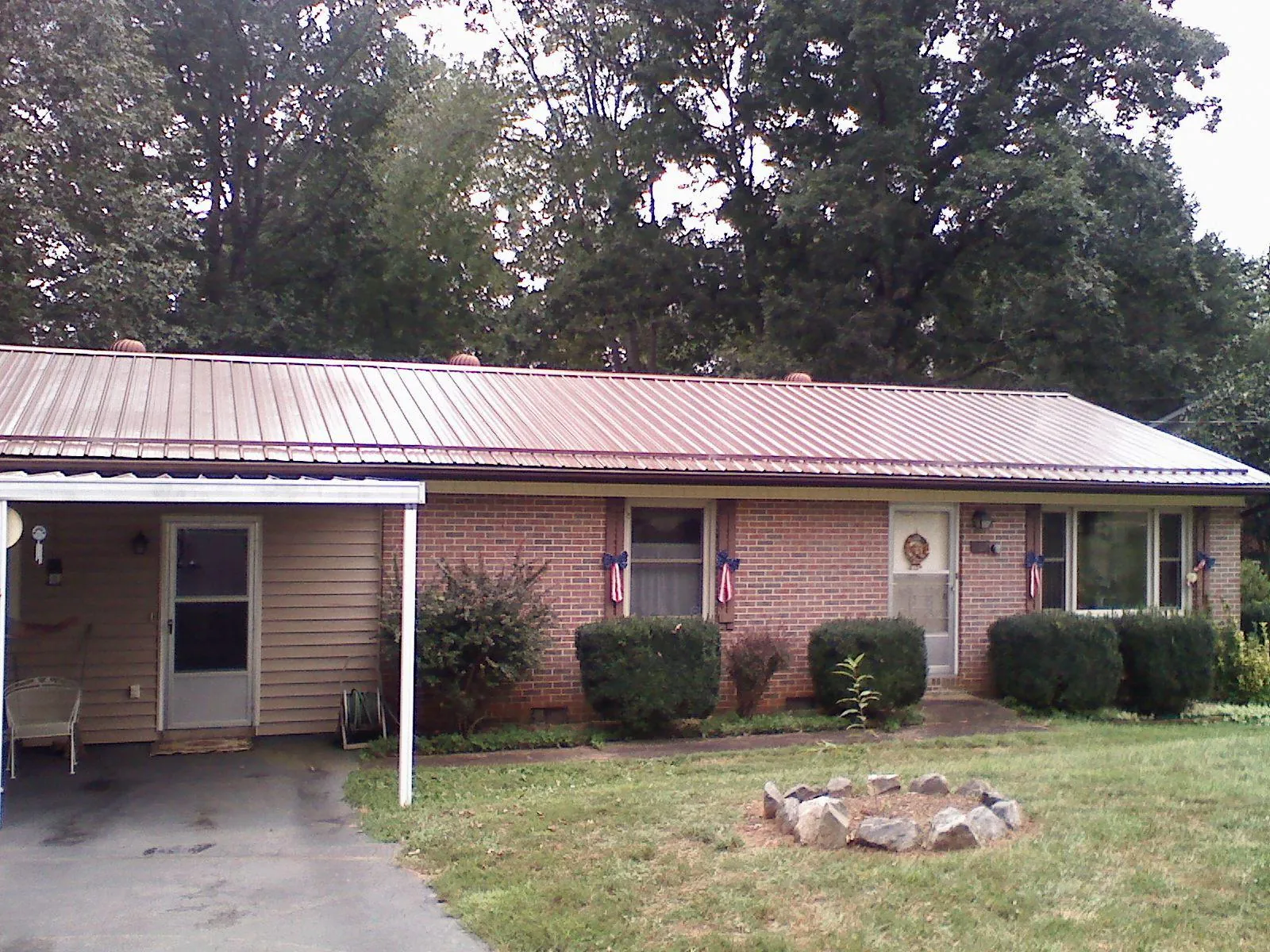 Bronze metal roof and carport on a brick ranch home — Roof Repair work by our crew in San Dimas